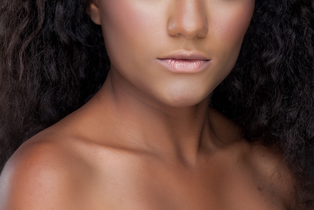 black woman's collarbones highlighted by makeup