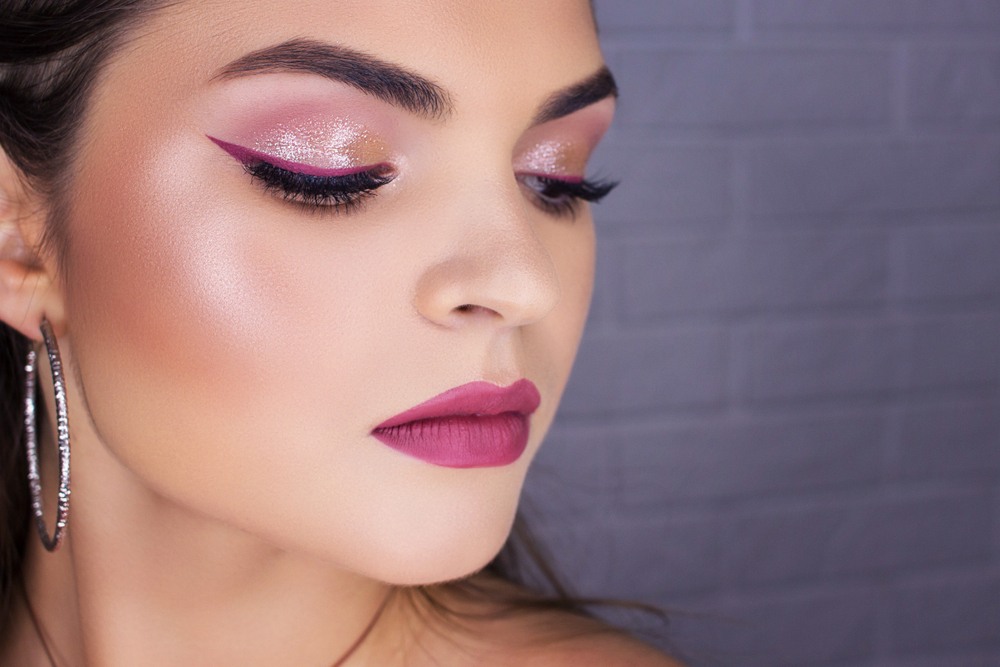 woman with pink eyeshadow looks downward