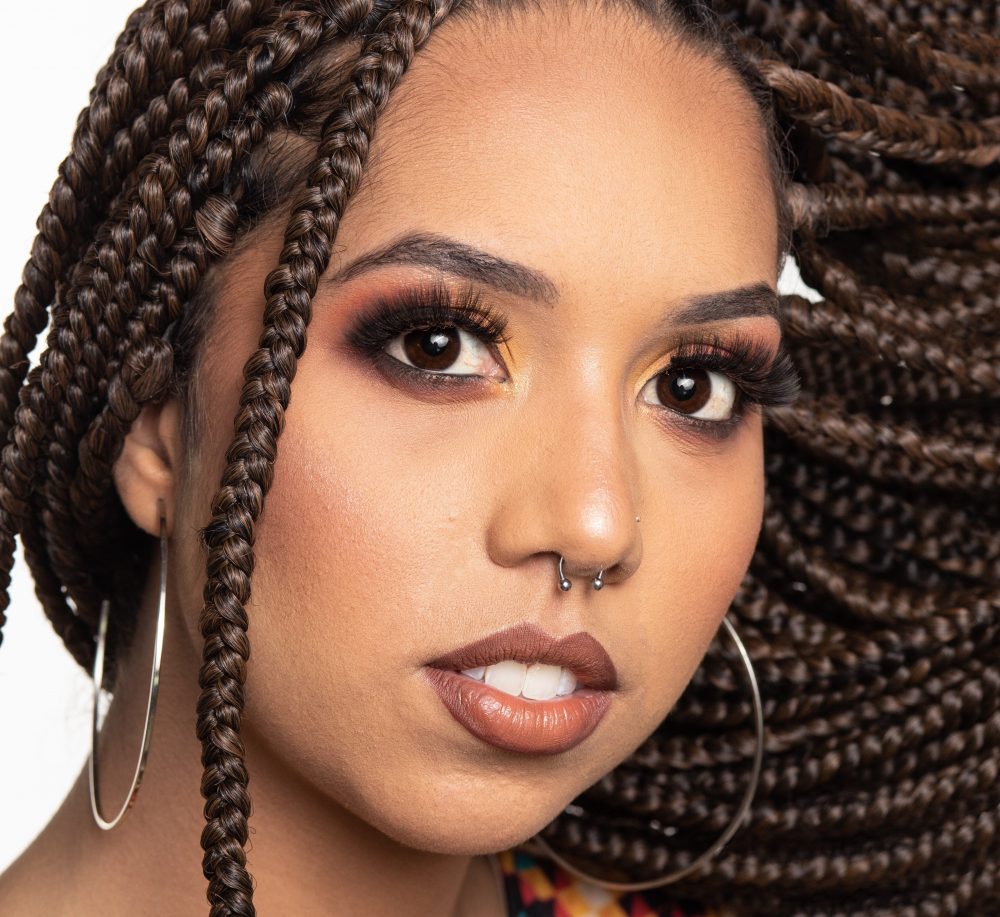 black woman with braids and thick mascara 