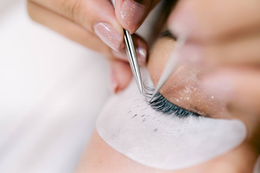 esthetician placing eyelash ex