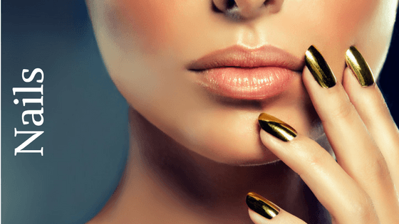 woman with shiny gold nails