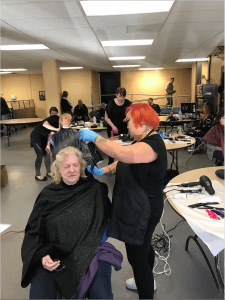 phagans student cutting hair for a homeless person at portland rescue mission