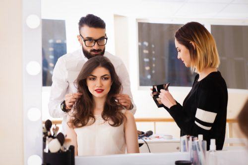 beauty school student learning from instructor