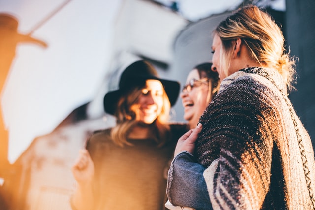 Women talking in a group outside