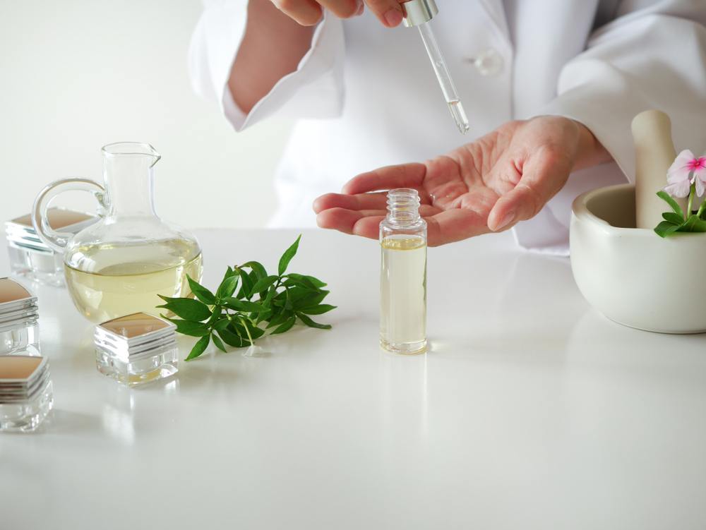 Scientist tests facial oils.