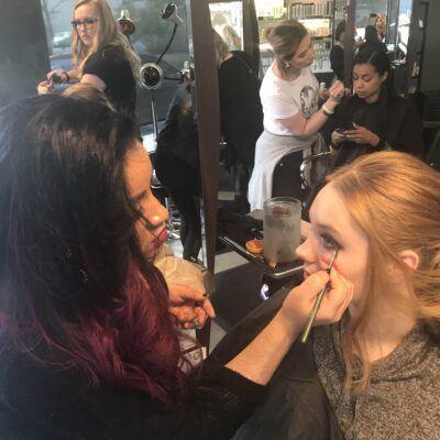 Make up artist putting makeup on a client