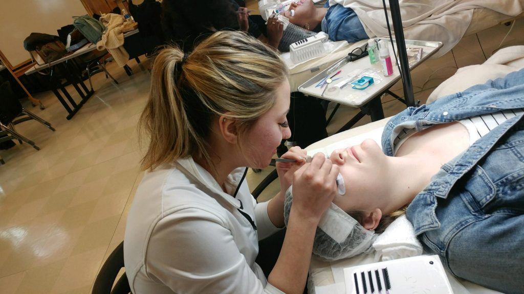 A group of phagans student working on their lash extension certification