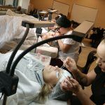 A group of phagans student working on their lash extension certification