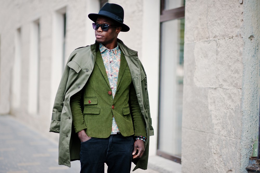 fashionable man wearing flowered shirt, hat and jacket