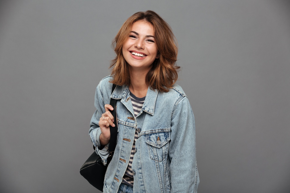 young woman laughing with back pack