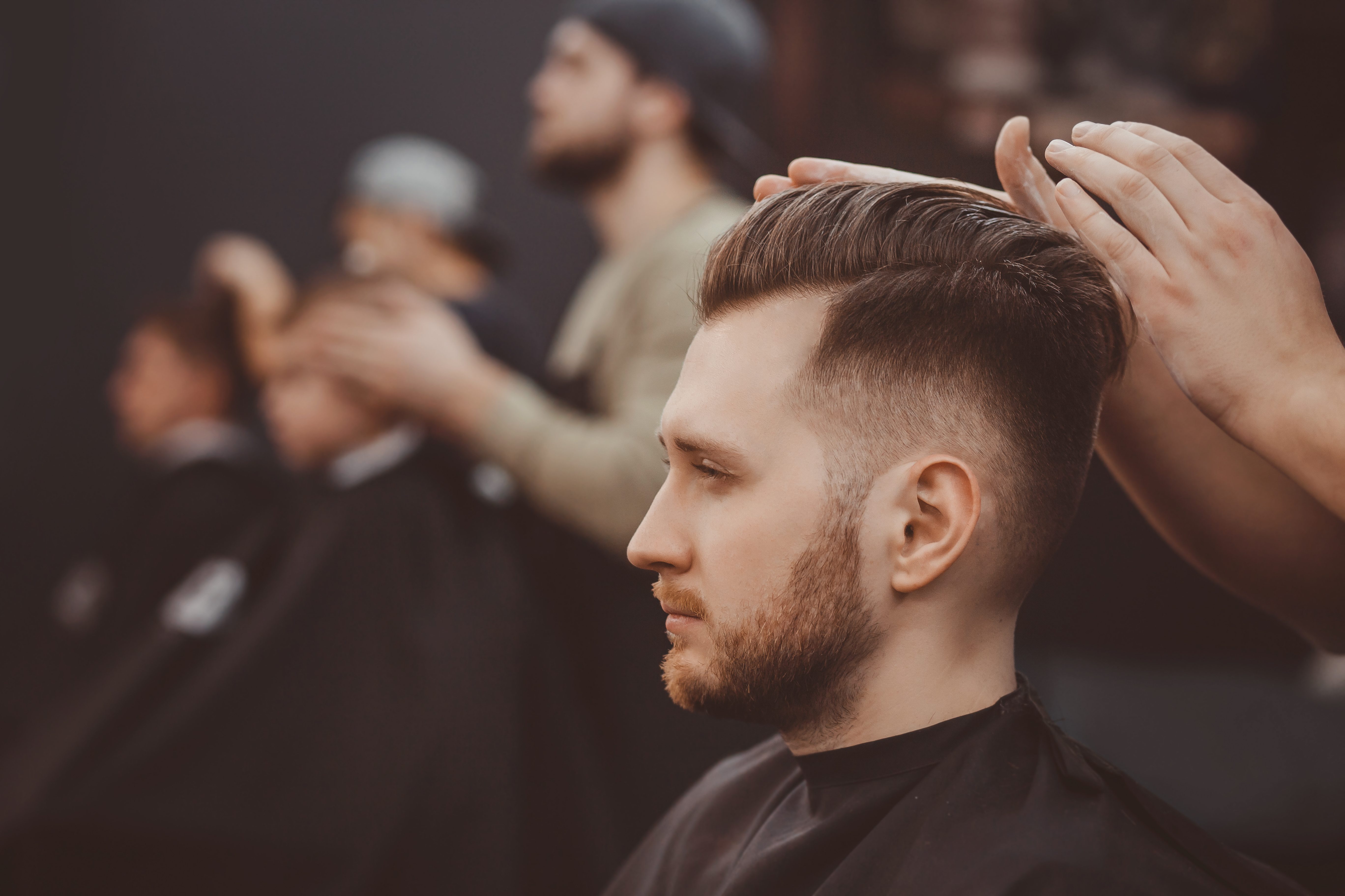 man receiving haircut