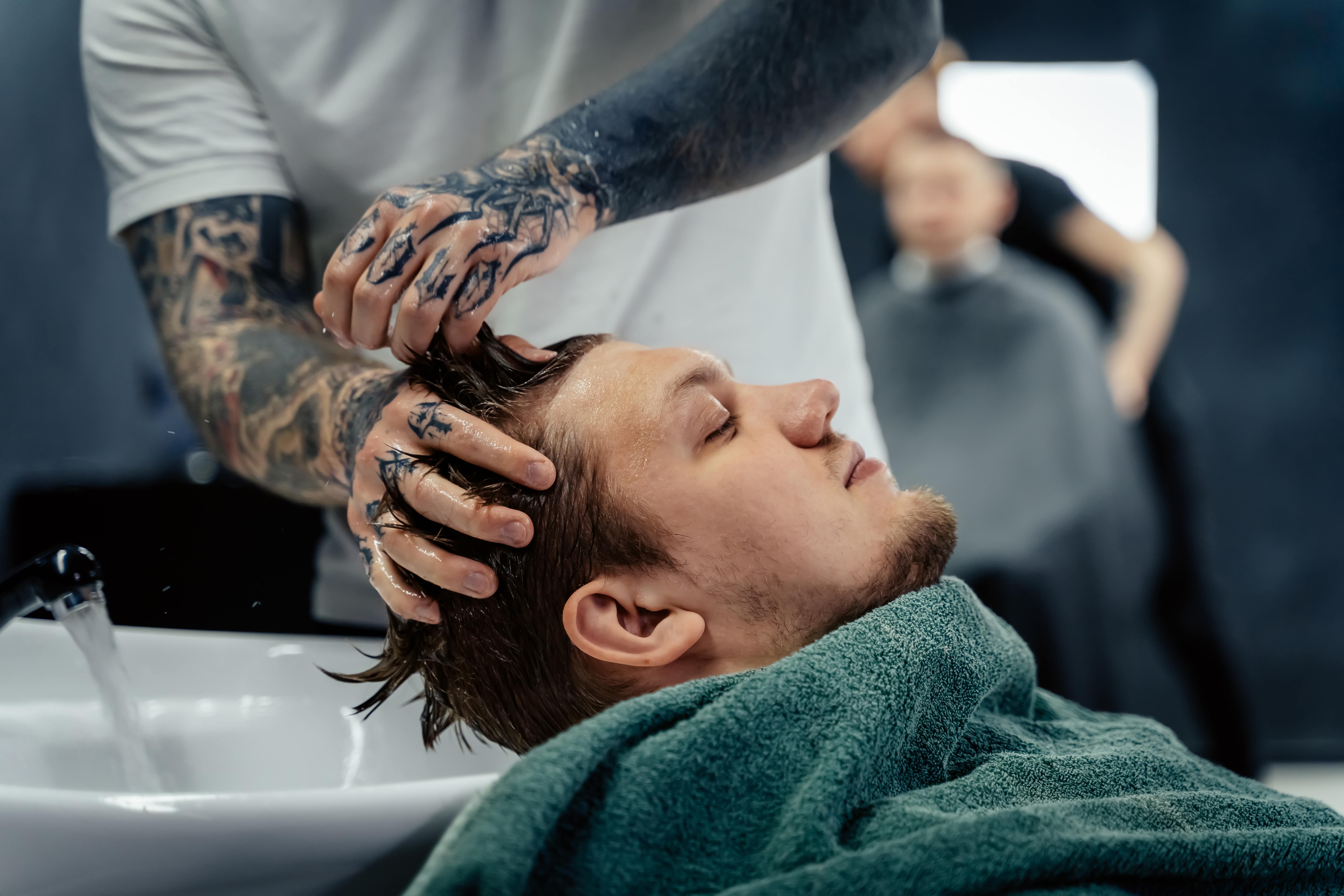 man receiving shampoo at barbershop