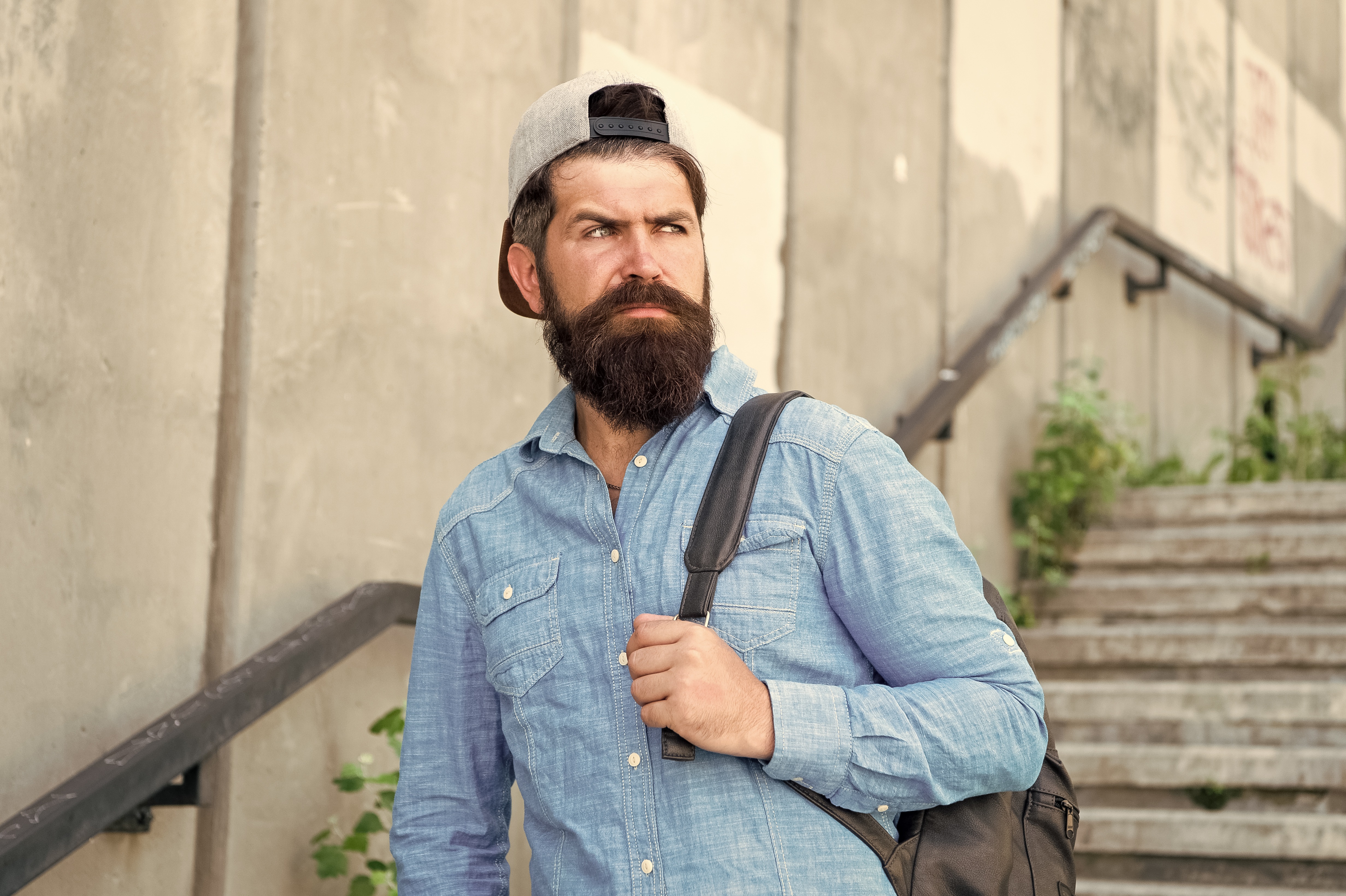 barber walking down stairs with pack slung over his shoulder