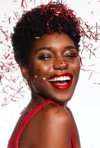 gorgeous woman with smoky eyeshadow surrounded by red confetti