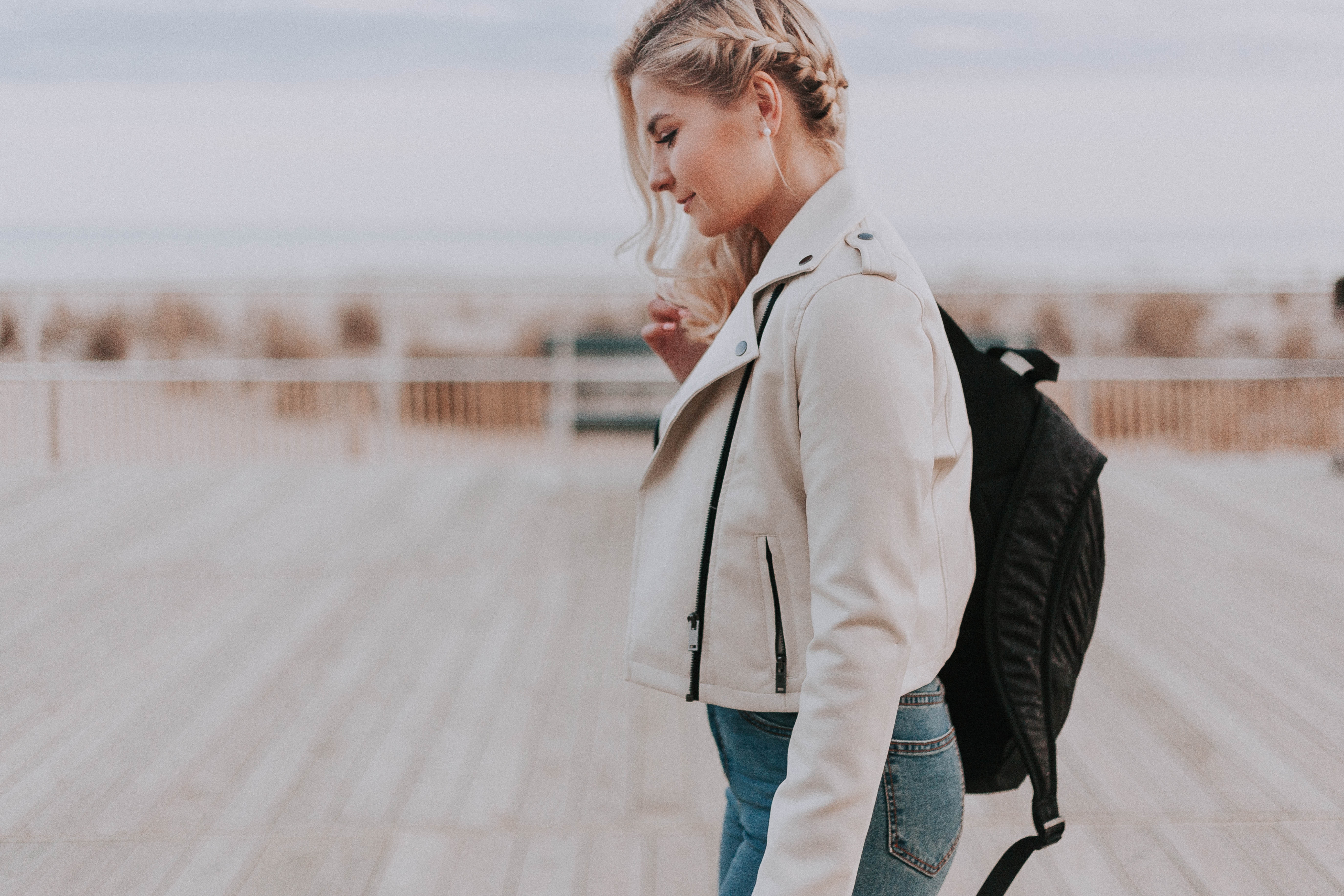 woman walking outside wearing a backpack