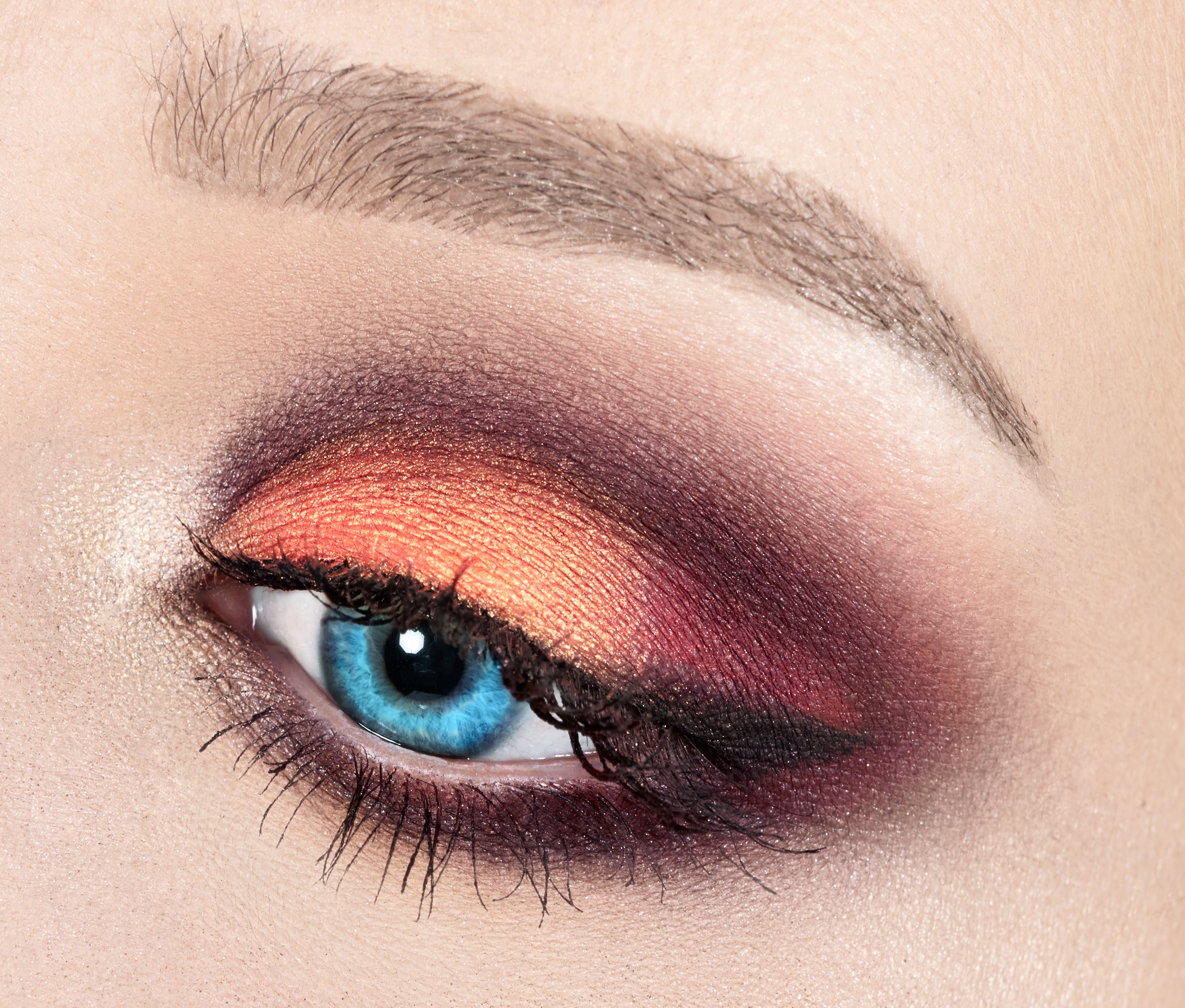 bright blue eye with red eye shadow