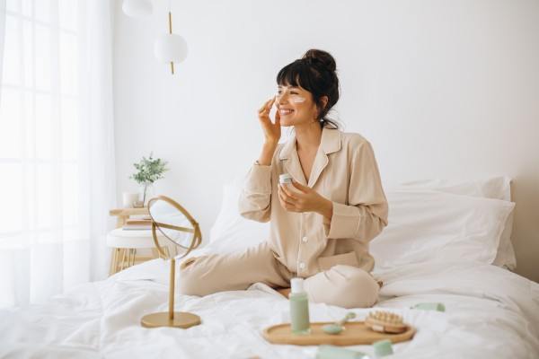 woman in pajamas wearing eye masks