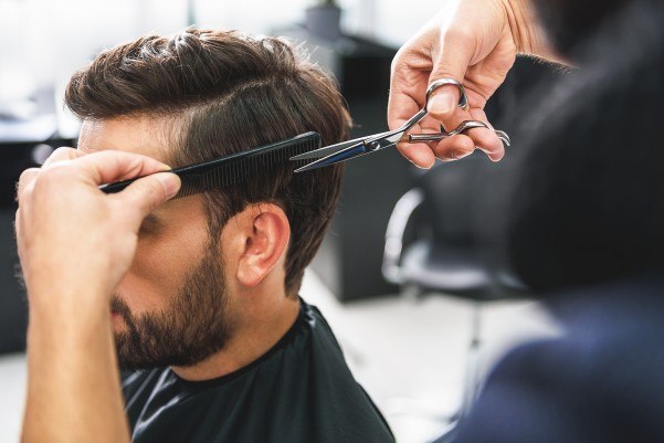 barber trimming hair